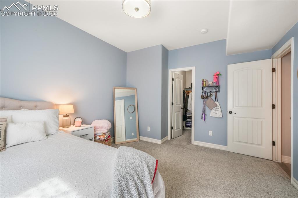 Image 42 of 50: Basement level family room with full wet bar and LVP flooring