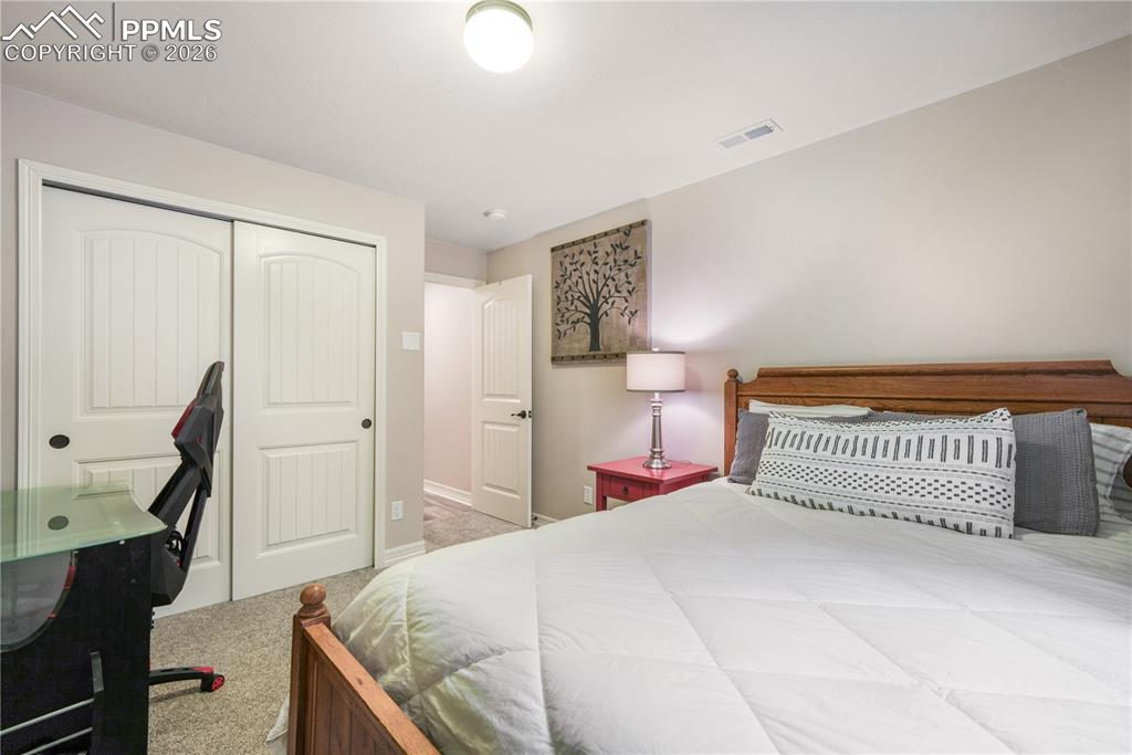 Image 45 of 50: Basement level 6th bedroom with large walk in closet and en suite access to