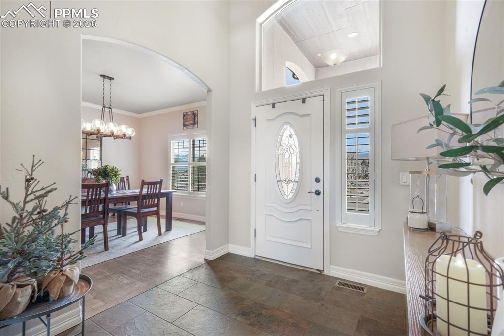 Image 6 of 50: Back of home, private landscaped and fenced yard, views of Pikes Peak