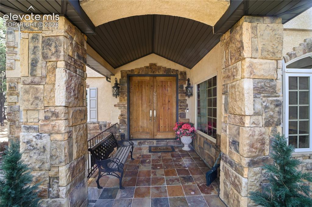 Image 14 of 50: Large double doors represent an Old World Shield and steps into a sandstone