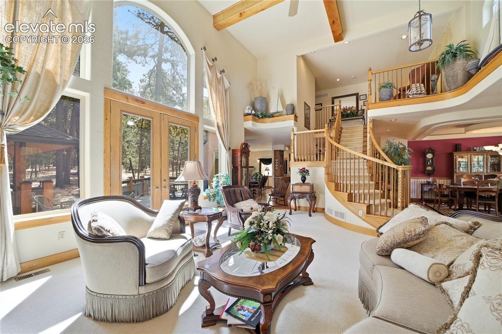 Image 17 of 50: 2 Story high ceiling, wood beams, butternut woodwork.