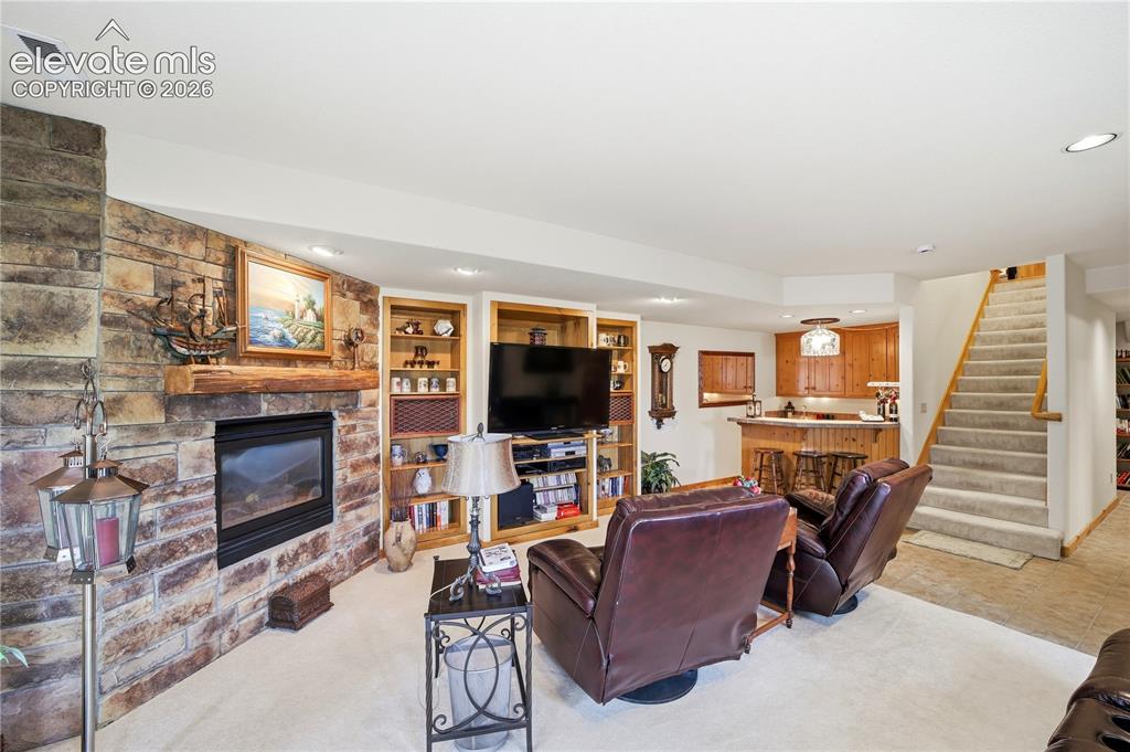 Image 30 of 50: Lower level family room with fireplace