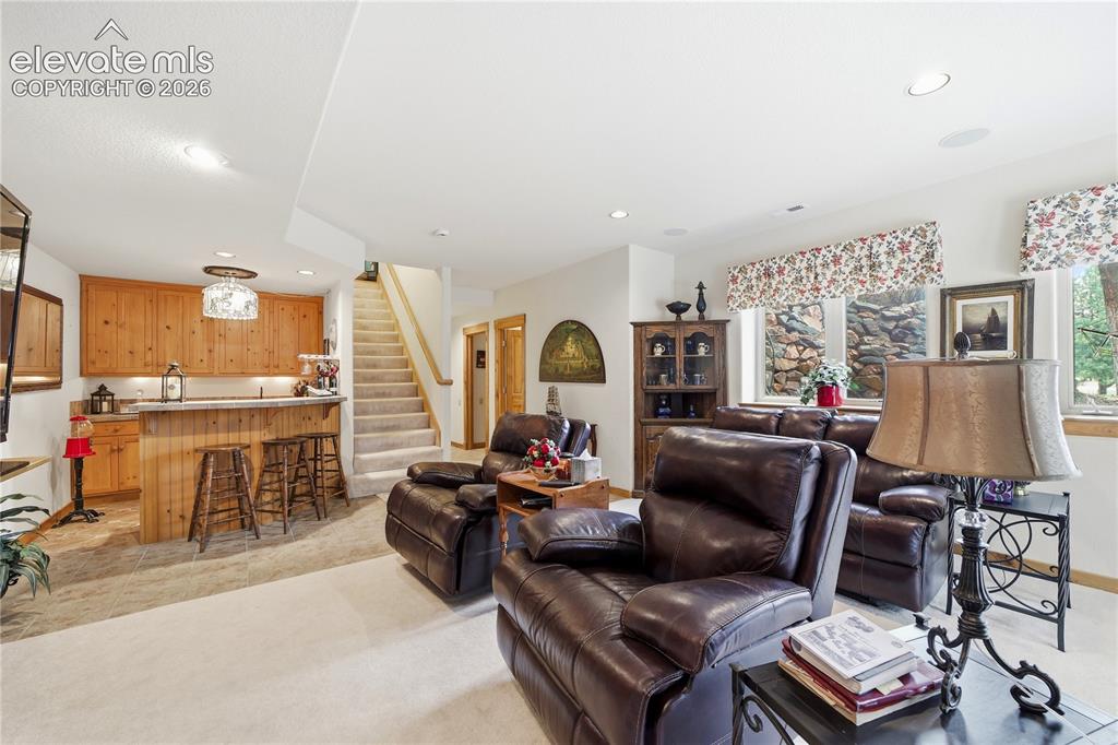 Image 31 of 50: Lower level Family Room with Walk Out to Side Patio