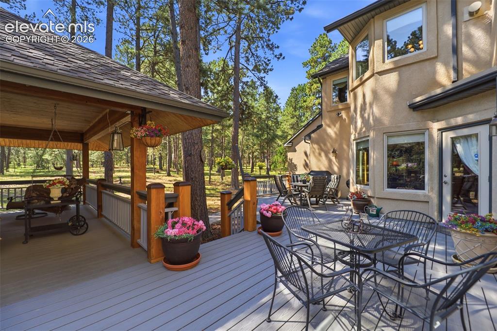 Image 4 of 50: There is sun filled deck that is not covered and a covered deck as well