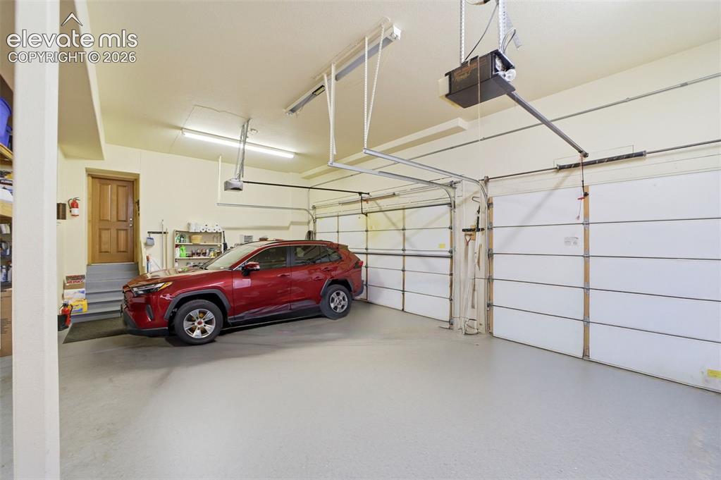 Image 44 of 50: Attached Garage fits 3 Cars and is oversized with depth for garage freezers