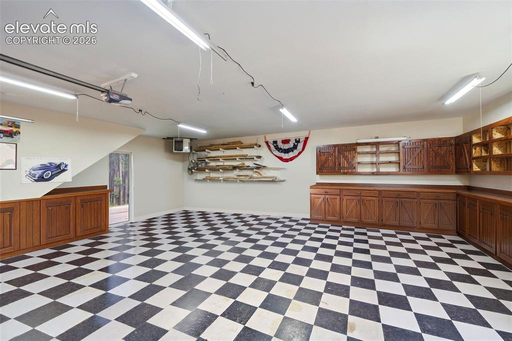Image 45 of 50: Detached Garage Heated with cabinets and Space for 3 Cars