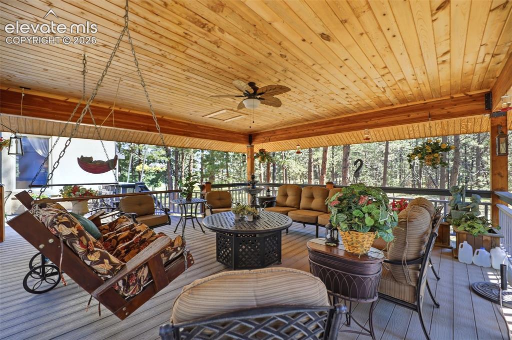 Image 5 of 50: Covered deck was an addition that adds year round outdoor enjoyment.