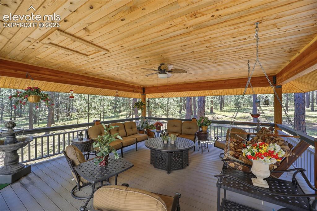 Image 6 of 50: Year round outdoor living space in this covered deck