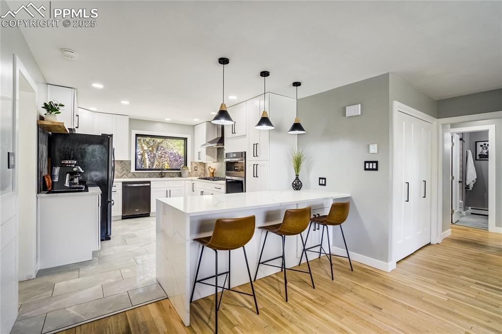 Image 14 of 46: Quartz counters w/ waterfall island