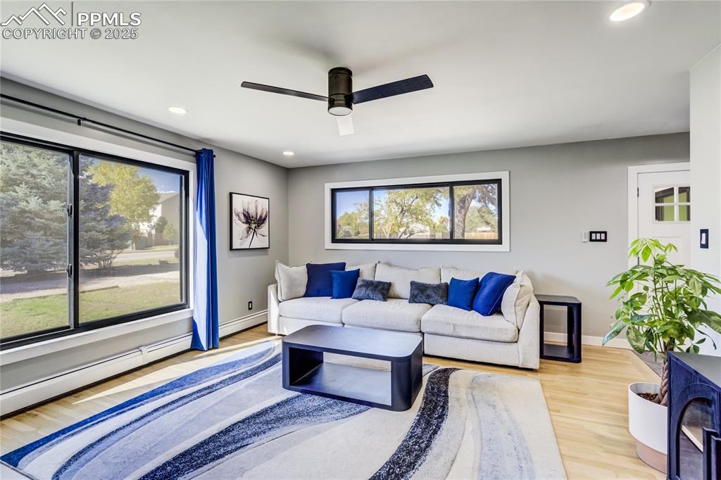 Image 8 of 46: Lots of natural light & refinished wood flooring