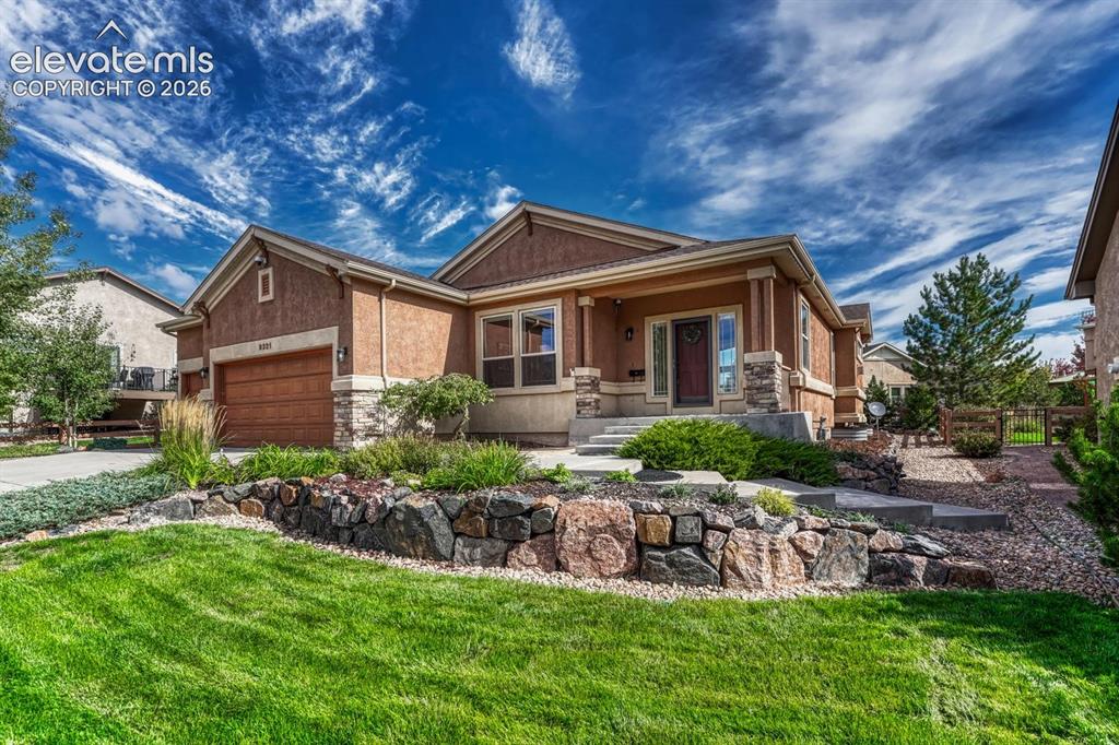 Image 15 of 50: Great curb appeal with beautiful professional landscaping and raised rock p