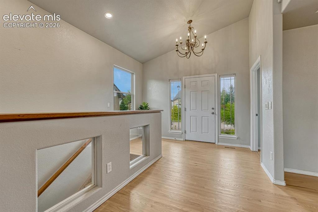 Image 17 of 50: Welcoming Front Entry with wood flooring, side lite windows and an attracti