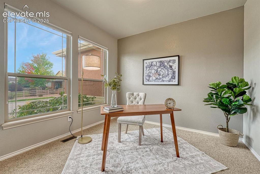 Image 18 of 50: The versatile front room provides space for a home office, nursery, or gues