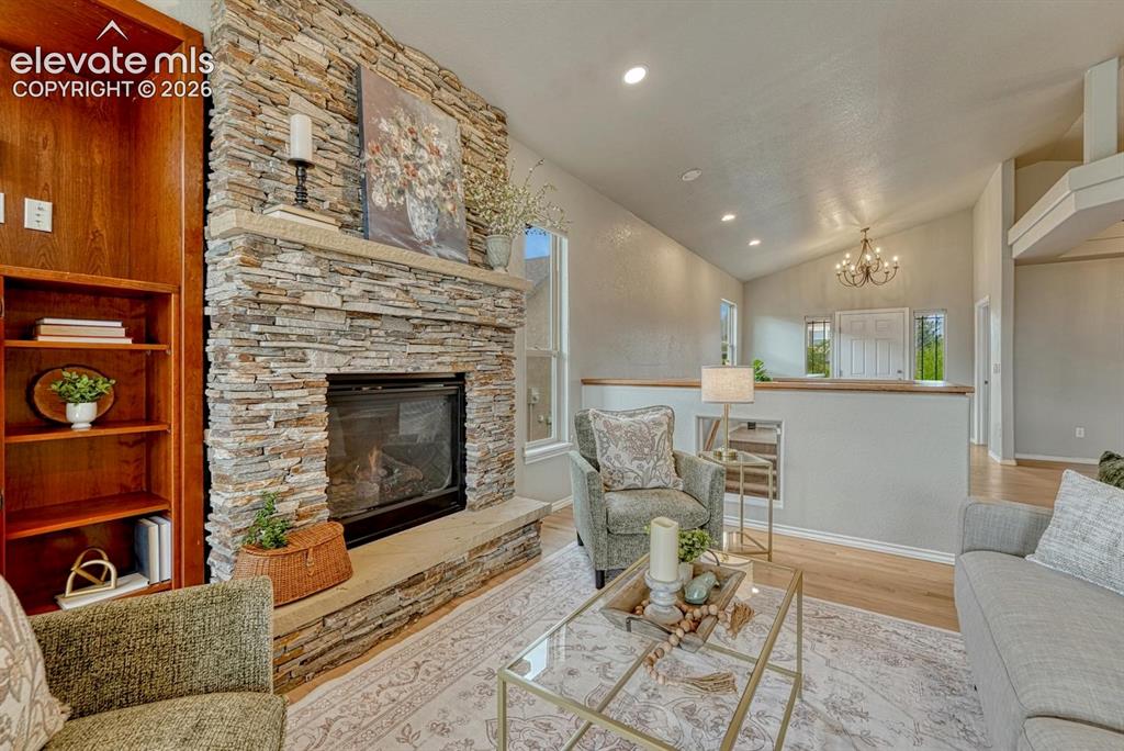 Image 22 of 50: Gorgeous gas fireplace in the Great Room with floor to ceiling stone surrou