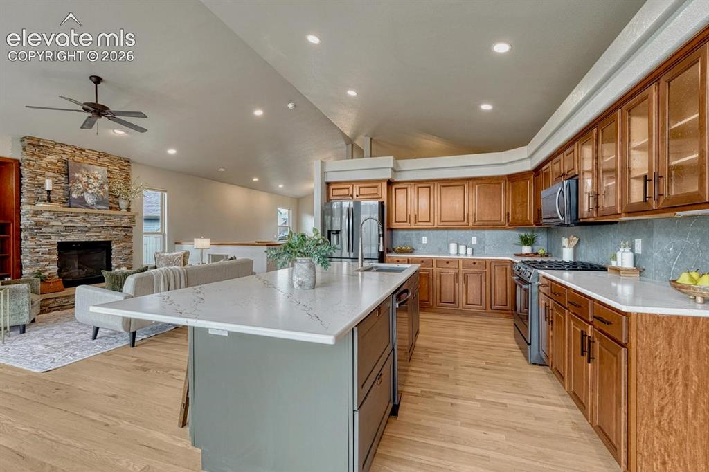Image 23 of 50: The gourmet kitchen showcases quartz countertops, a large island, abundant 