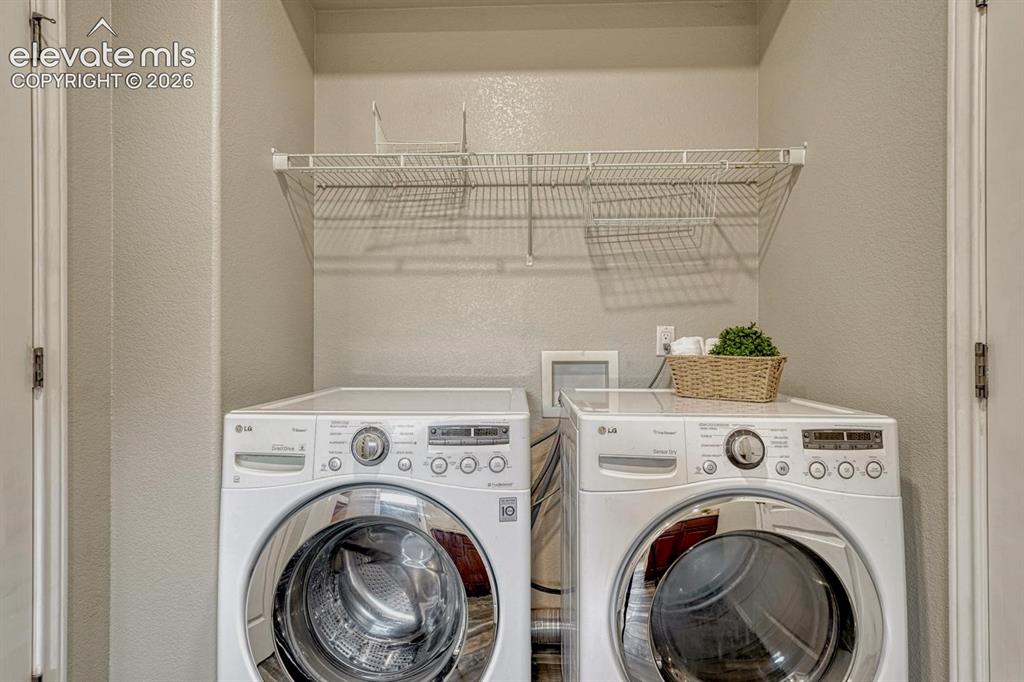 Image 32 of 50: The main level Laundry Room includes the washer and driver.