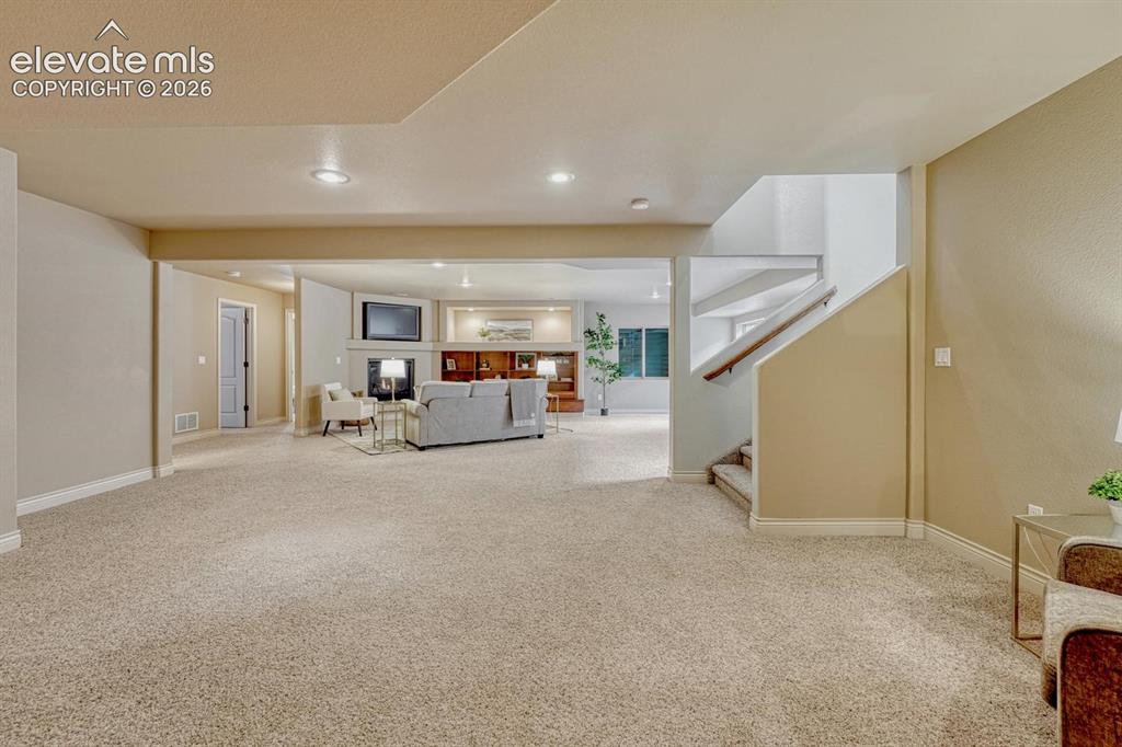Image 33 of 50: The basement expands the living space with a large family room featuring a 
