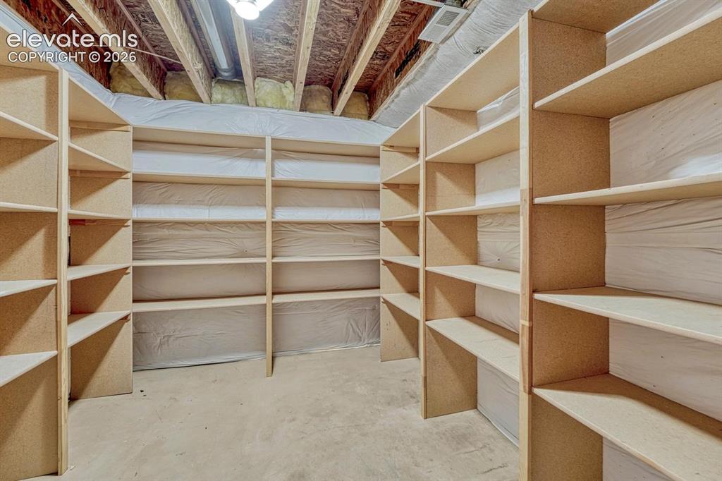 Image 41 of 50: Basement Storage Room with built-in shelves.