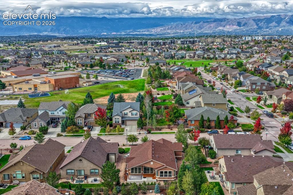 Image 44 of 50: Aerial view of the rear of the home and neighborhood including Ranch Creek 