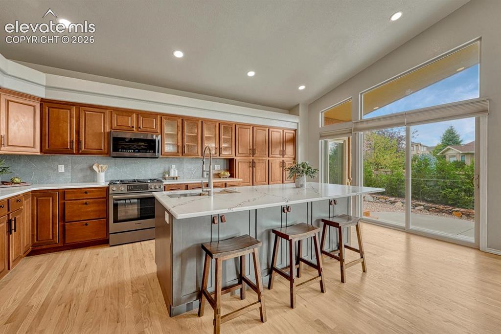 Image 5 of 50: The Gourmet Kitchen features a large island, breakfast bar, ample wood cabi