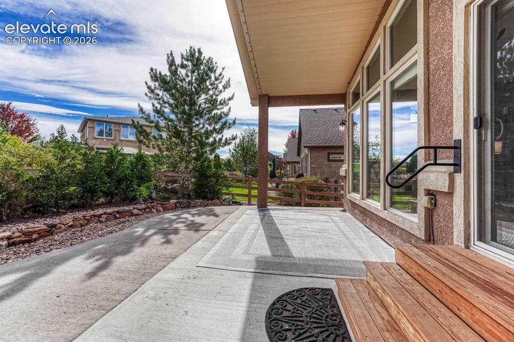 Image 7 of 50: Backyard patio with lots of trees for privacy and shade.