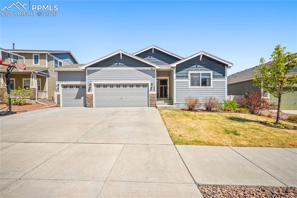 Image 1 of 44: 3 car garage, covered front porch and well maintained landscaping. 
