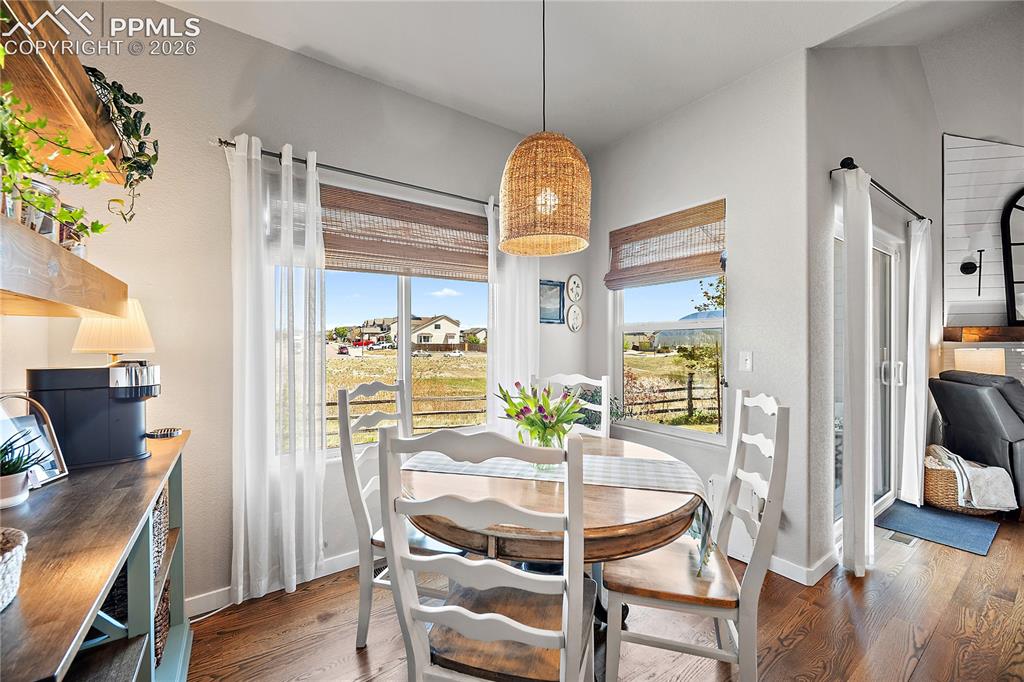 Image 14 of 44: Dining and walk out to covered patio and fenced back yard. 