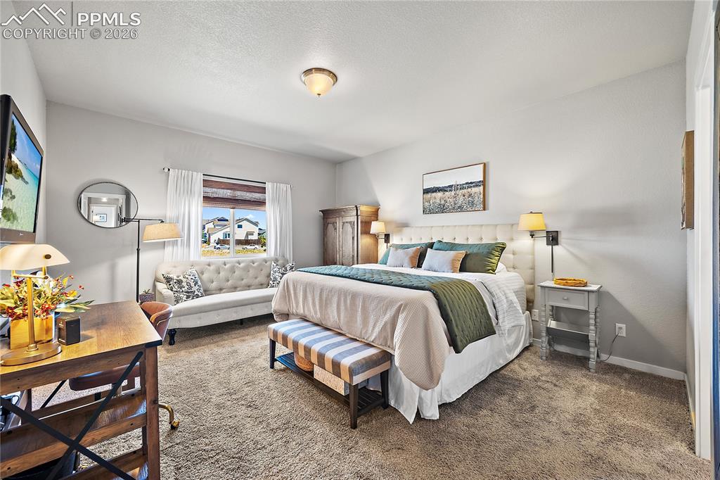 Image 18 of 44: Primary suite with carpet, ensuite bath and walk in closet