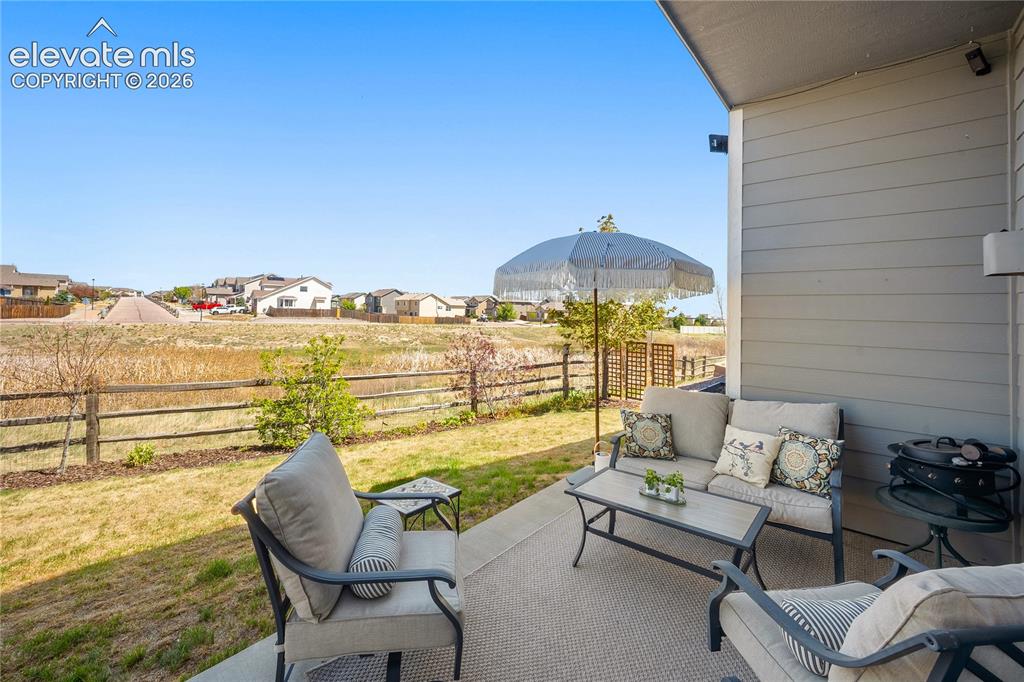 Image 2 of 44: Covered patio and fully fenced back yard. 