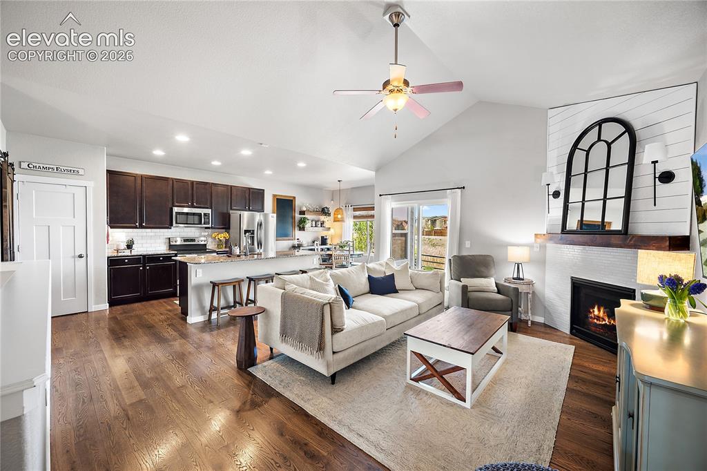 Image 5 of 44: Open concept living, dining and kitchen with vaulted ceiling and stunning h