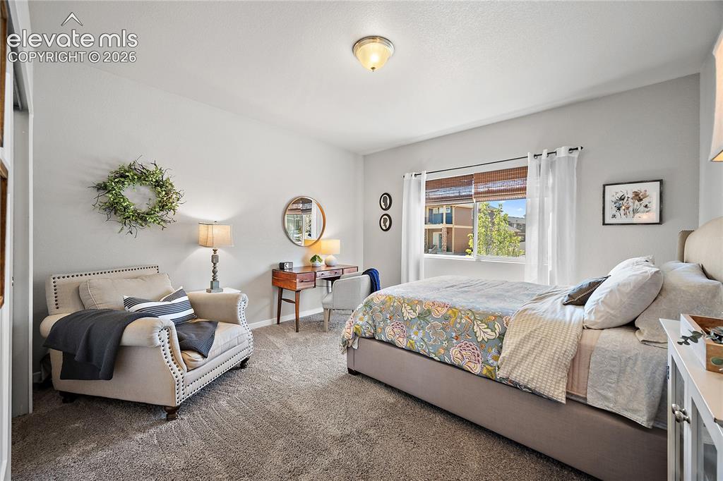 Image 8 of 44: Main level guest bedroom, large window allows for natural light. 