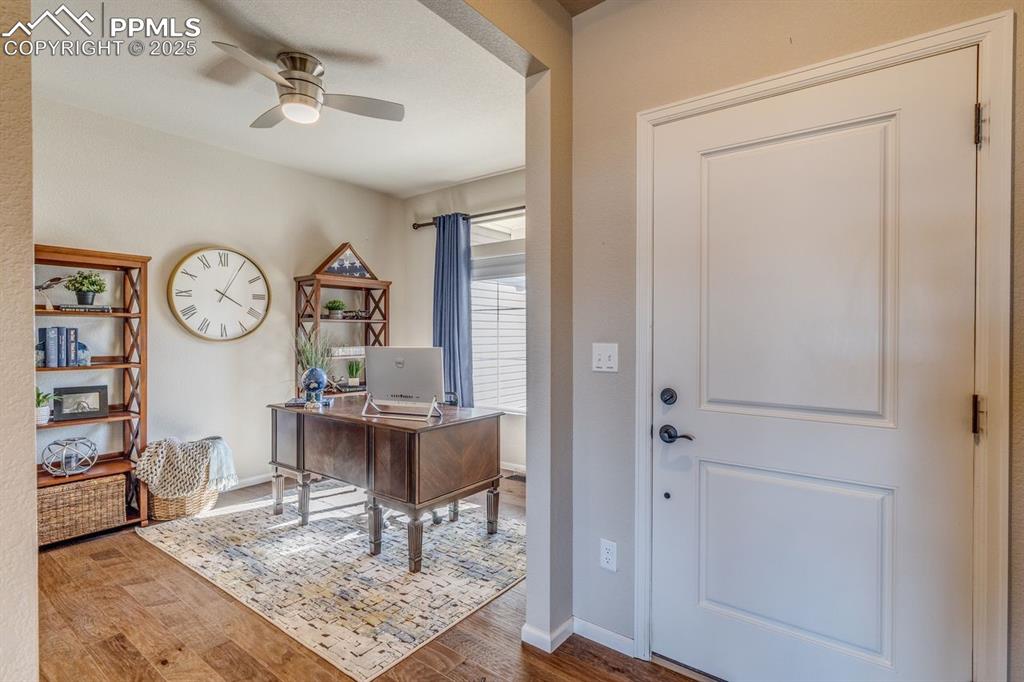 Image 13 of 50: Office featuring ceiling fan and wood finished floors