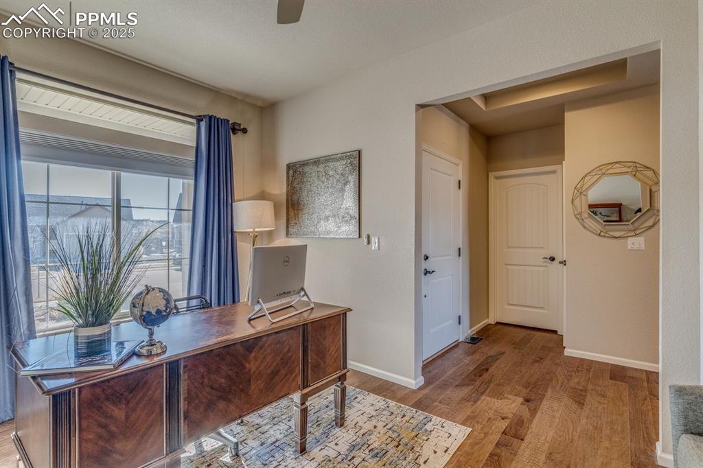 Image 14 of 50: Office space featuring light wood finished floors and ceiling fan