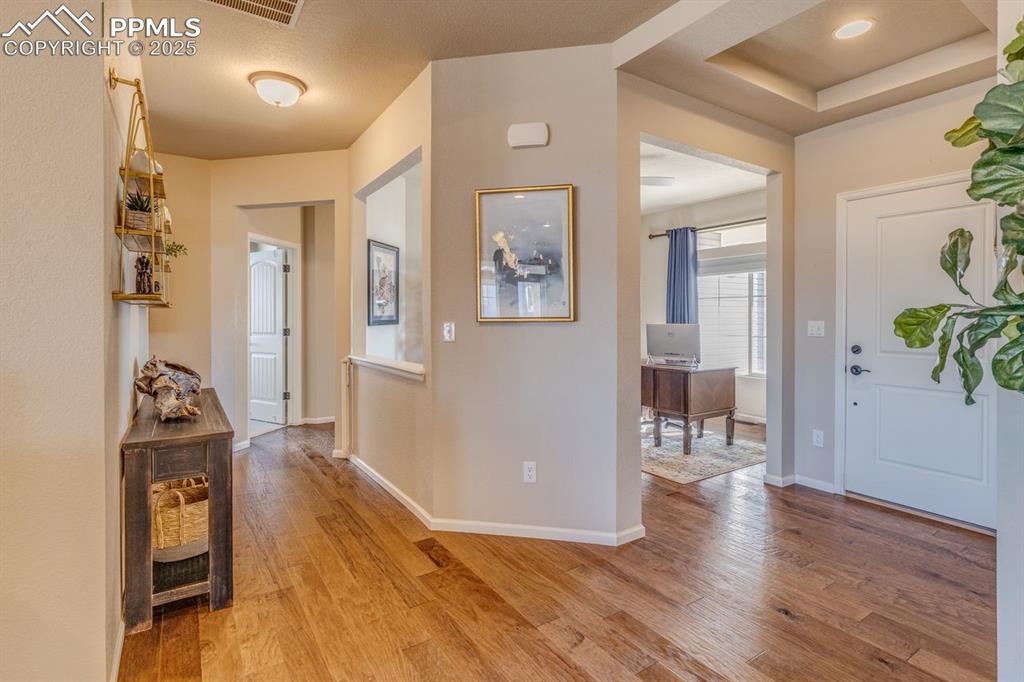 Image 17 of 50: Entryway with light wood finished floors and baseboards