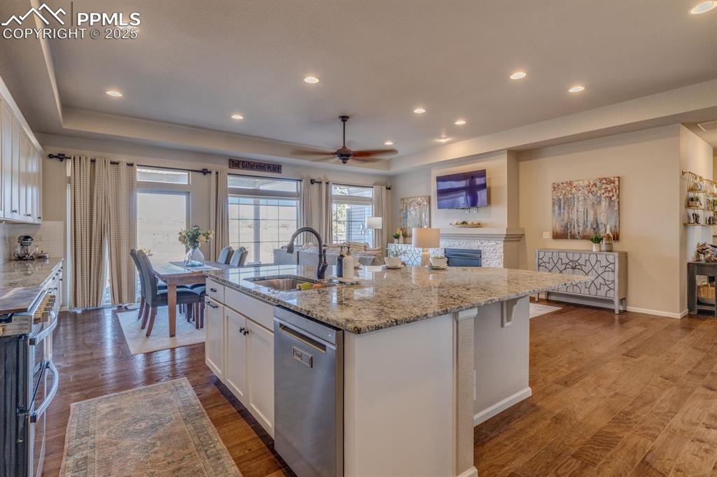Image 22 of 50: Kitchen featuring white cabinetry, appliances with stainless steel finishes