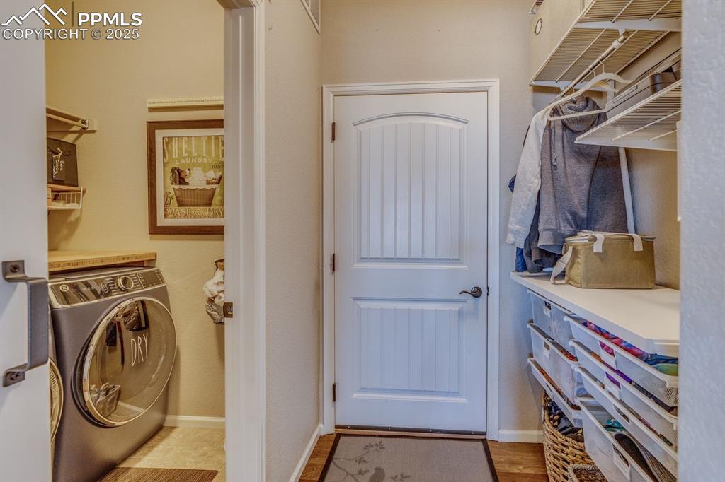 Image 25 of 50: Laundry room with washer / dryer and light wood-type flooring