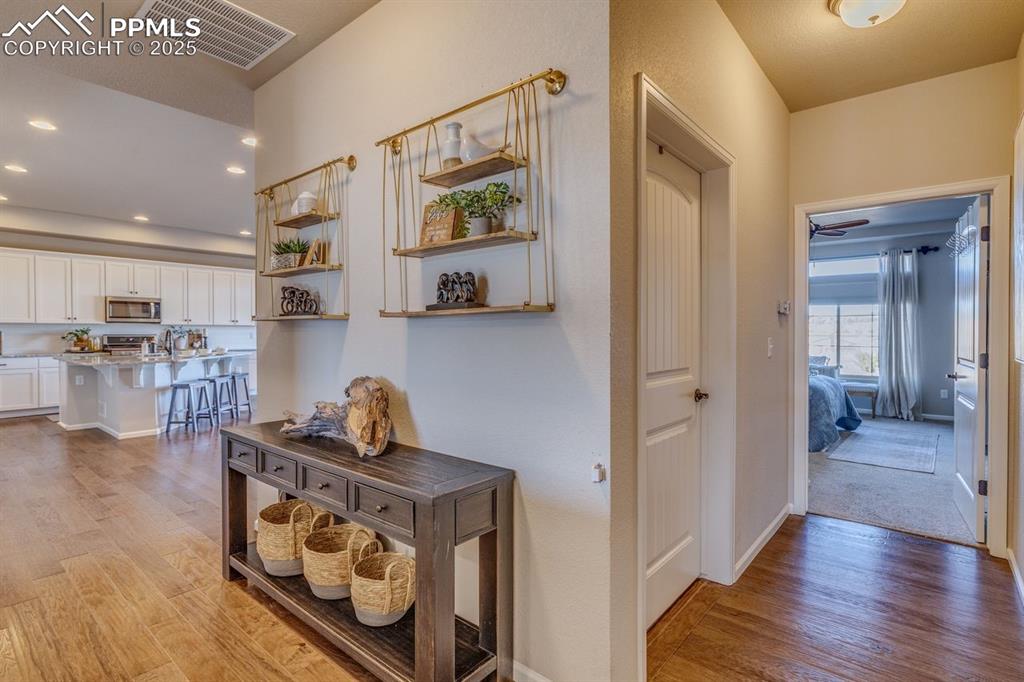 Image 27 of 50: Hallway with light wood-style flooring and recessed lighting
