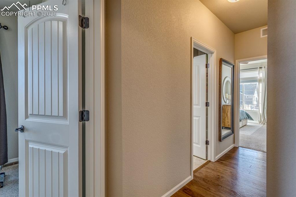 Image 32 of 50: From the primary bedroom the other 2 bedrooms and second bathroom. 