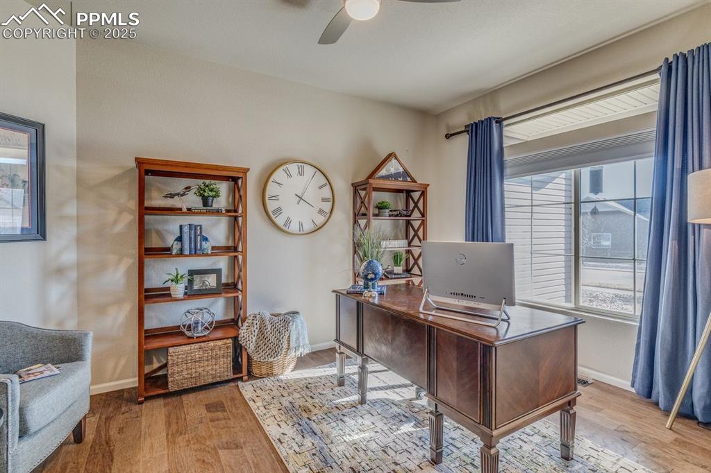 Image 5 of 50: Front room when you enter the door is being used as an office. Could be a f