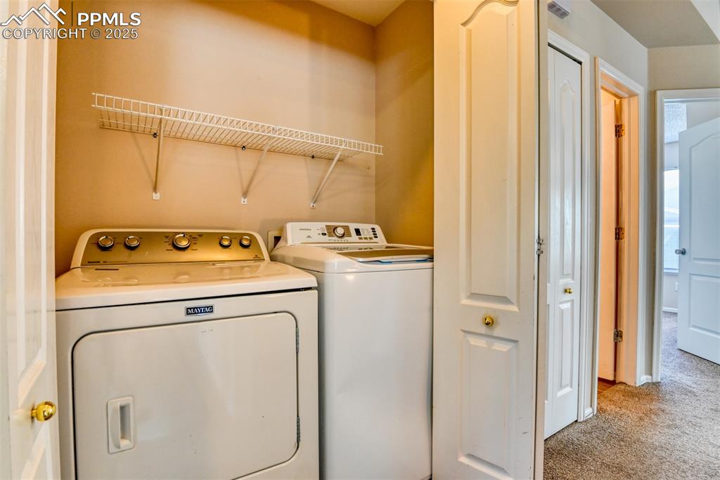 Image 17 of 36: Washroom with light carpet and independent washer and dryer