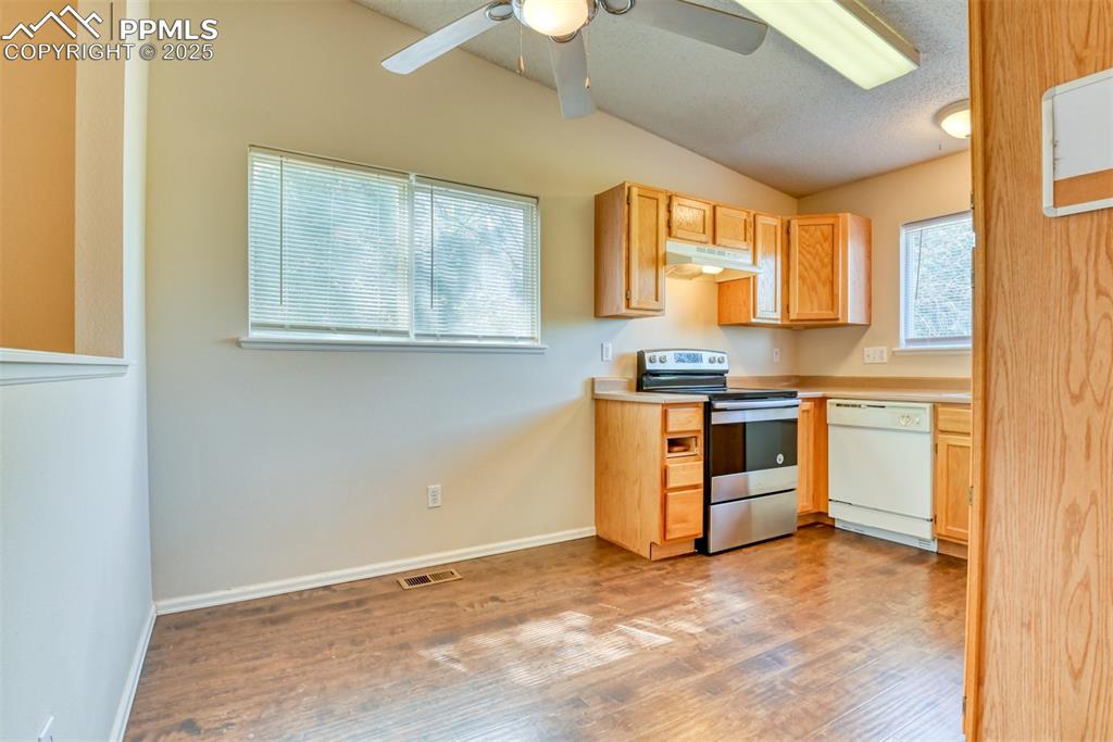 Image 6 of 36: Kitchen featuring stainless steel electric range oven, dishwasher, under ca