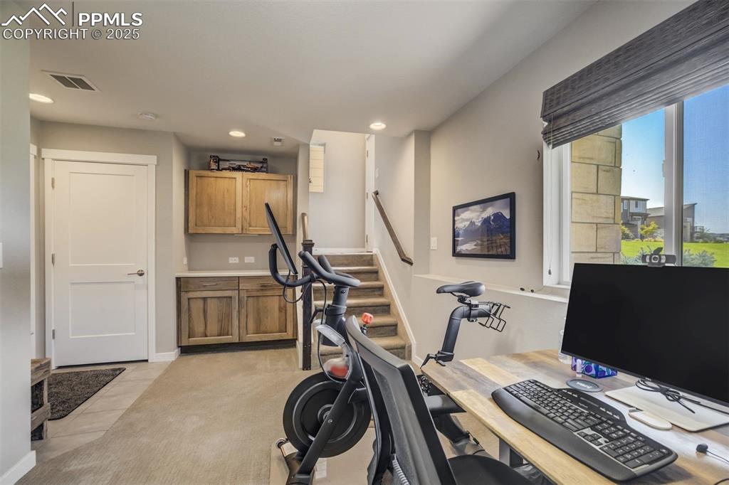 Image 34 of 45: lower level bonus room with cabinets, under stair storage