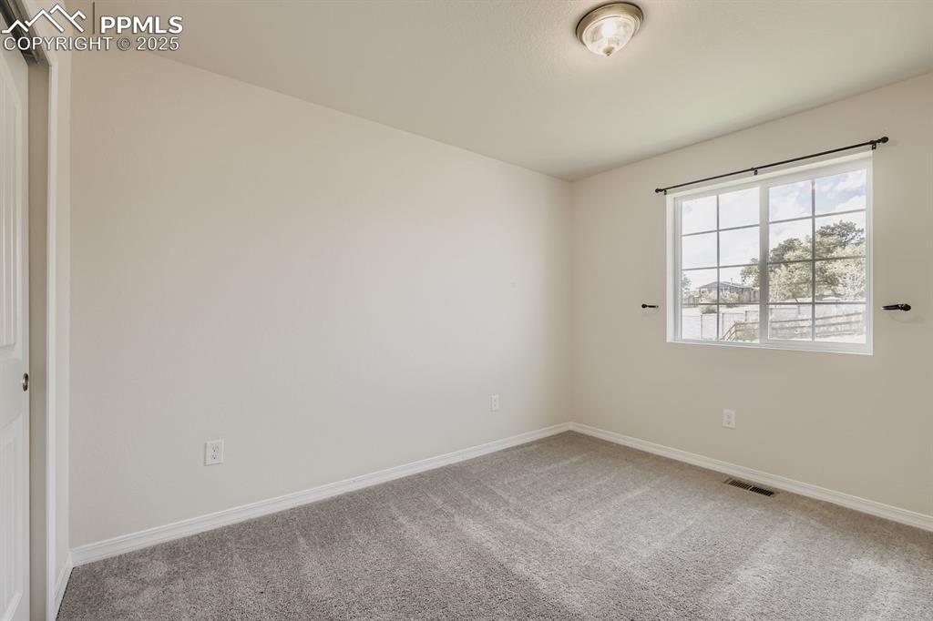Image 15 of 26: Empty room with light carpet and baseboards