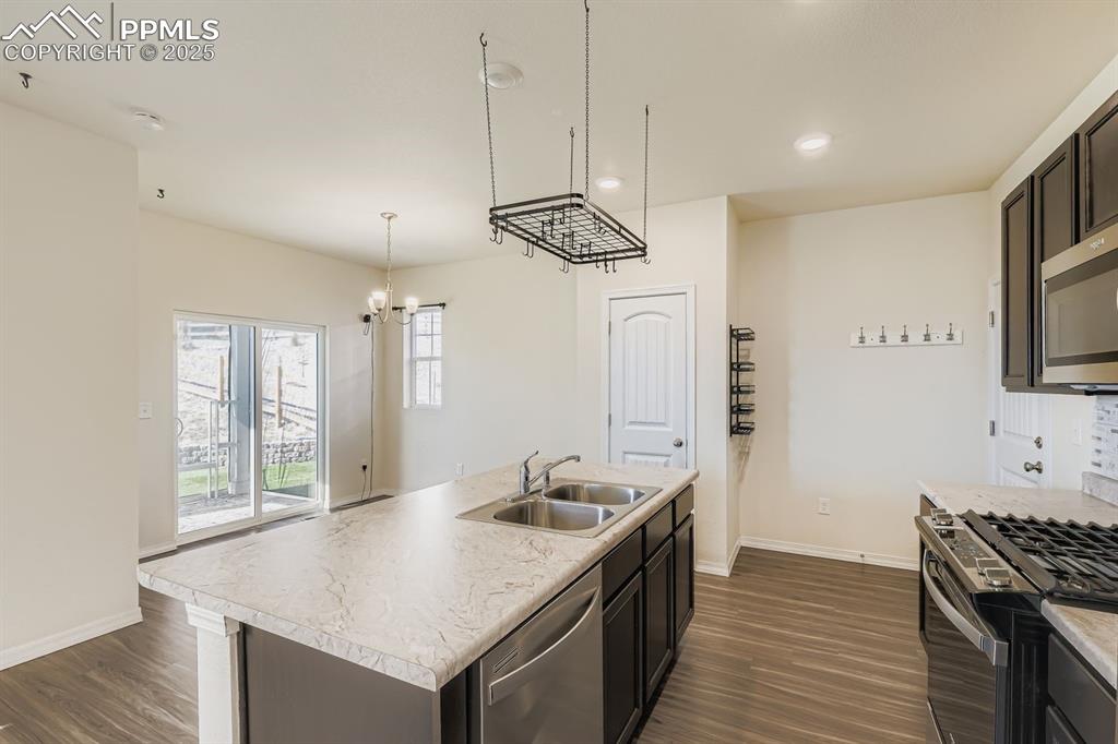 Image 18 of 26: Unfurnished room with light colored carpet, plenty of natural light, and re