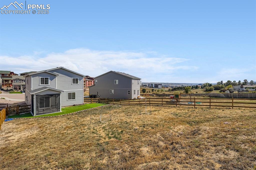 Image 2 of 26: View of fenced backyard