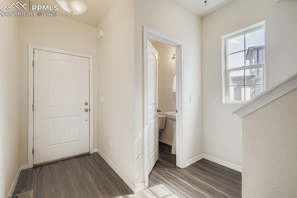 Image 23 of 26: Foyer featuring dark wood-style flooring