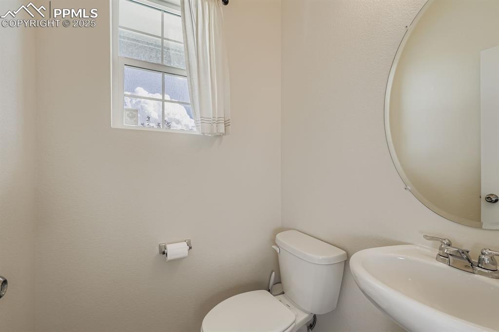 Image 24 of 26: Bathroom with toilet and a sink