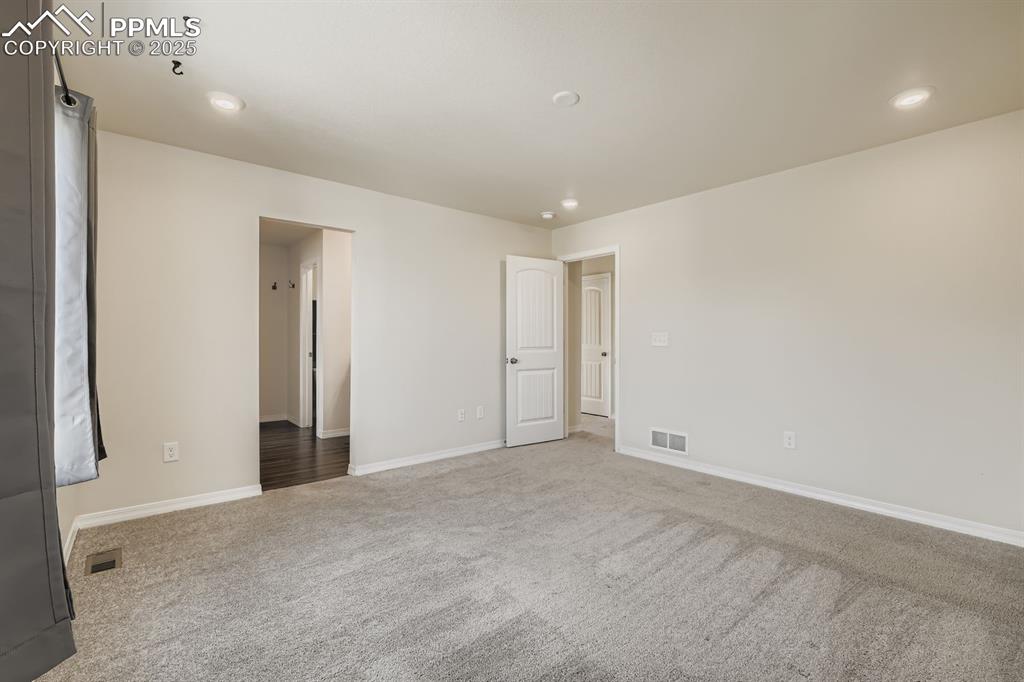 Image 8 of 26: Empty room with carpet and recessed lighting