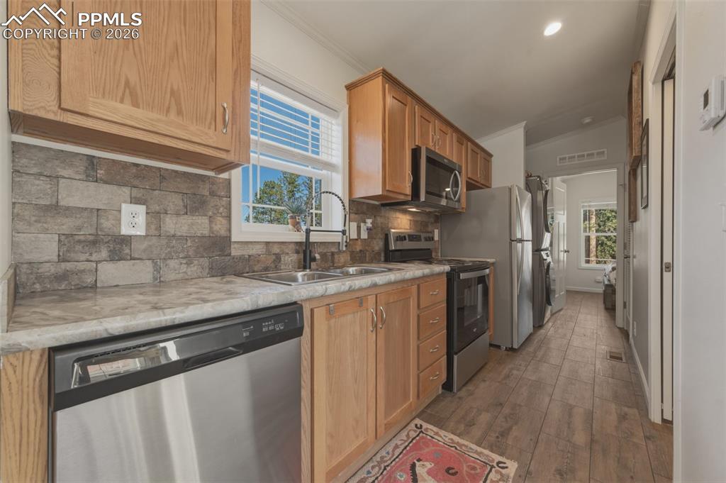 Image 12 of 23: Kitchen is well equipped with stainless appliances