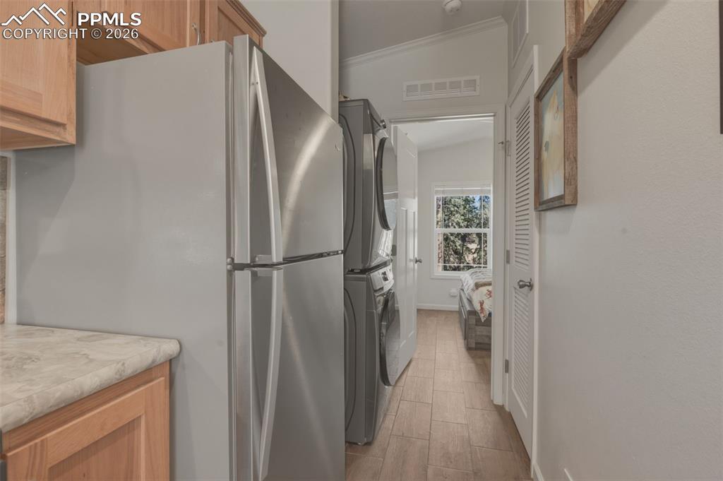 Image 15 of 23: Kitchen looking toward bedroom and laundry area